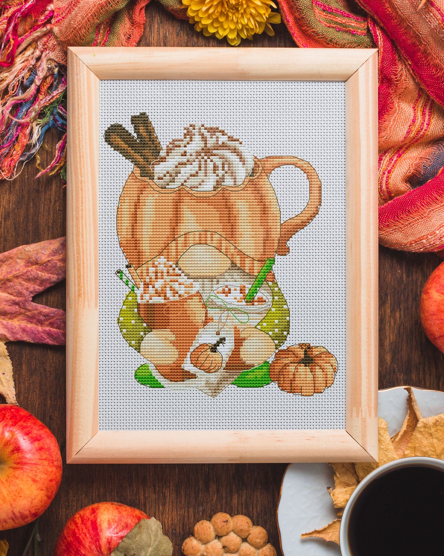 Cross stitch pattern of a Gnome with a pumpkin dessert.