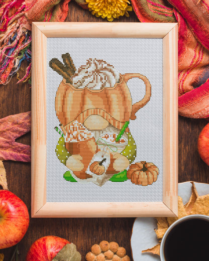 Cross stitch pattern of a Gnome with a pumpkin dessert.