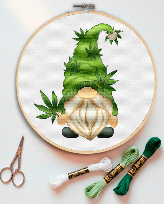 Cross stitch pattern of a Cannabis Gnome with a green leaf design.