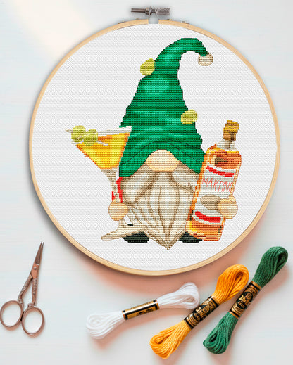 Cross stitch pattern of a Martini Gnome holding a glass with an olive. Cute cocktail-themed gnome embroidery design. Digital PDF pattern for home bar.