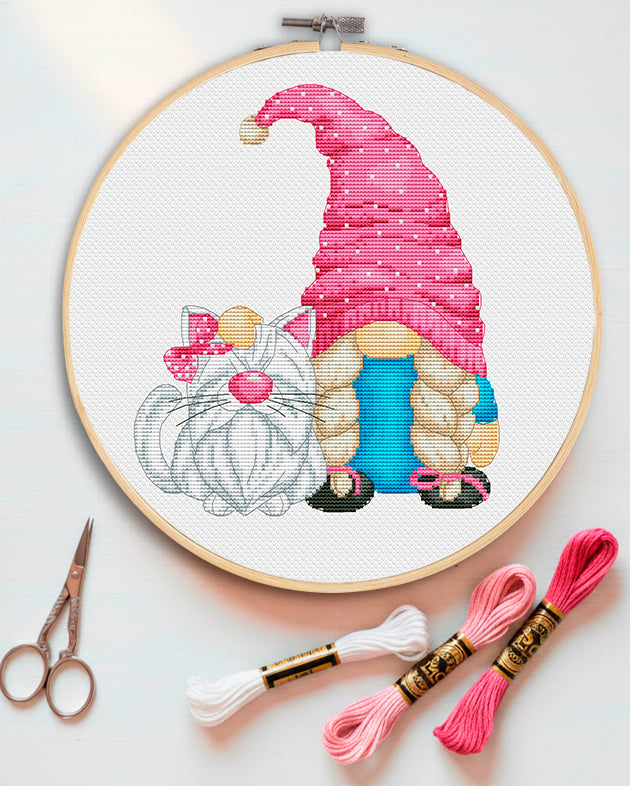 Cross stitch pattern of a cat lover gnome with kittens.