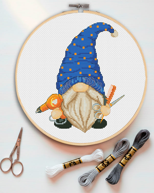 Cross stitch pattern of a Hairdresser Gnome with scissors and comb.