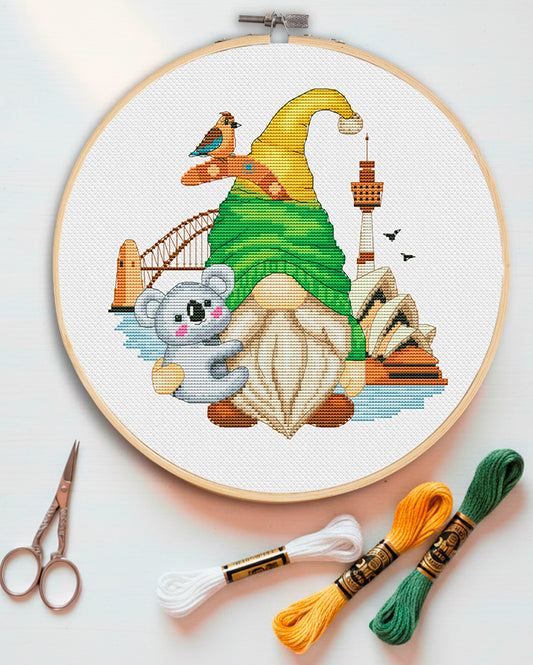 Cross stitch pattern of an Australian Gnome with a kangaroo and sun hat.