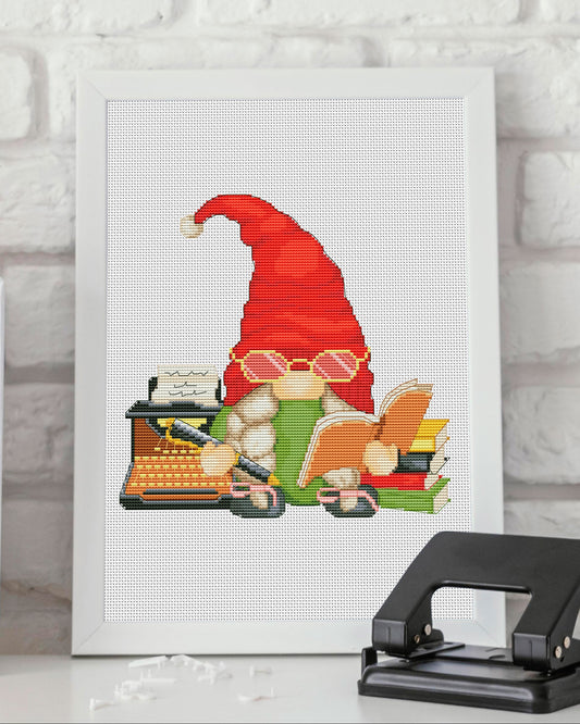 Cross-stitched gnome with a typewriter on a white background with books and a hole puncher.