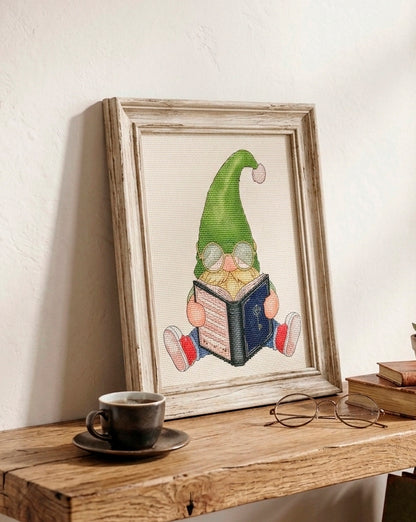 Book gnome cross stitch finished and framed in rustic wooden frame displayed on shelf with coffee cup — CuteBroidery 
