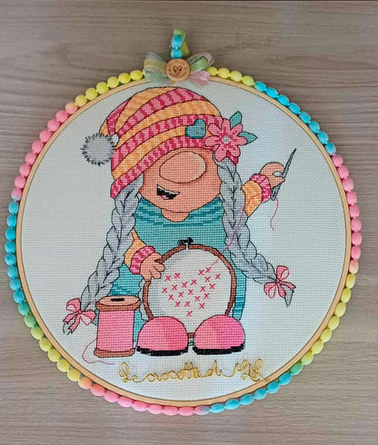 Stitching gnome girl cross stitch displayed in embroidery hoop with colorful pom pom trim — CuteBroidery customer finish